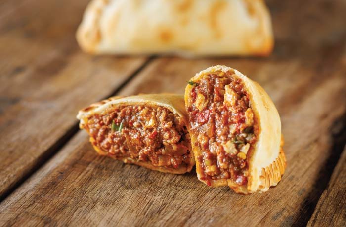 Empanada de carne cortada al medio mostrando su relleno